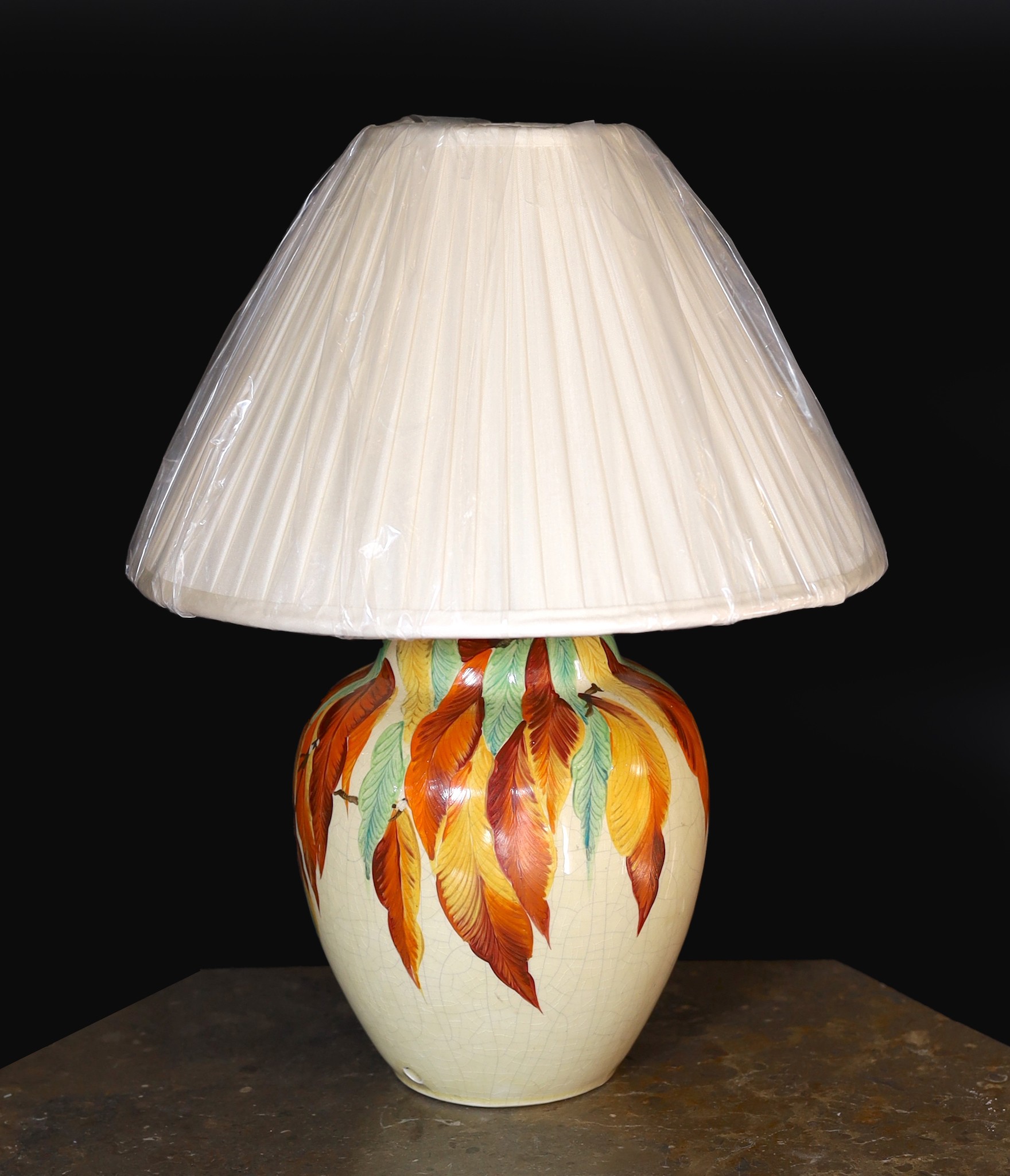 A 1930s English hand-painted pottery lamp base by Wait and Son of Midsham, Surrey, decorated with the autumn leaves, height without shade 27cm